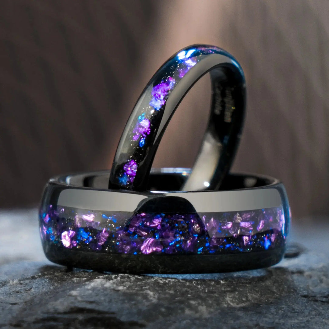 Capricornus black tungsten wedding rings from CouplesChoices.com, featuring crushed Alexandrite inlays with shifting violet and blue tones, designed for a bold and cosmic-inspired look.