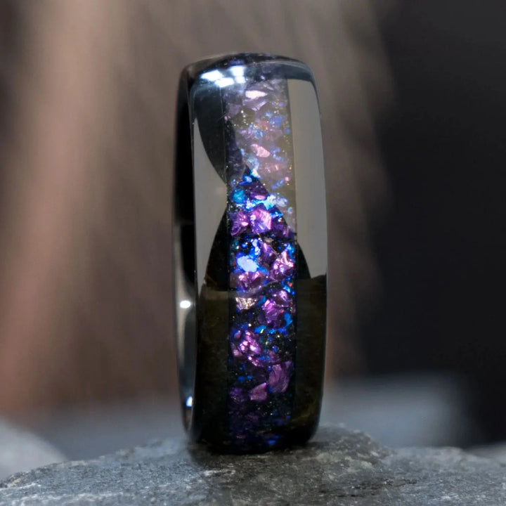 Capricornus black tungsten wedding rings from CouplesChoices.com, featuring crushed Alexandrite inlays with shifting violet and blue tones, designed for a bold and cosmic-inspired look.