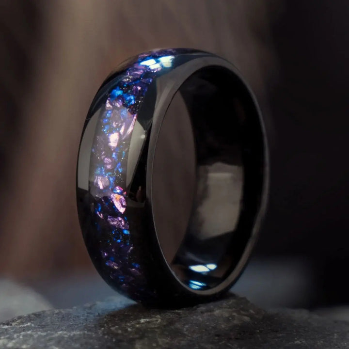 Capricornus black tungsten wedding rings from CouplesChoices.com, featuring crushed Alexandrite inlays with shifting violet and blue tones, designed for a bold and cosmic-inspired look.