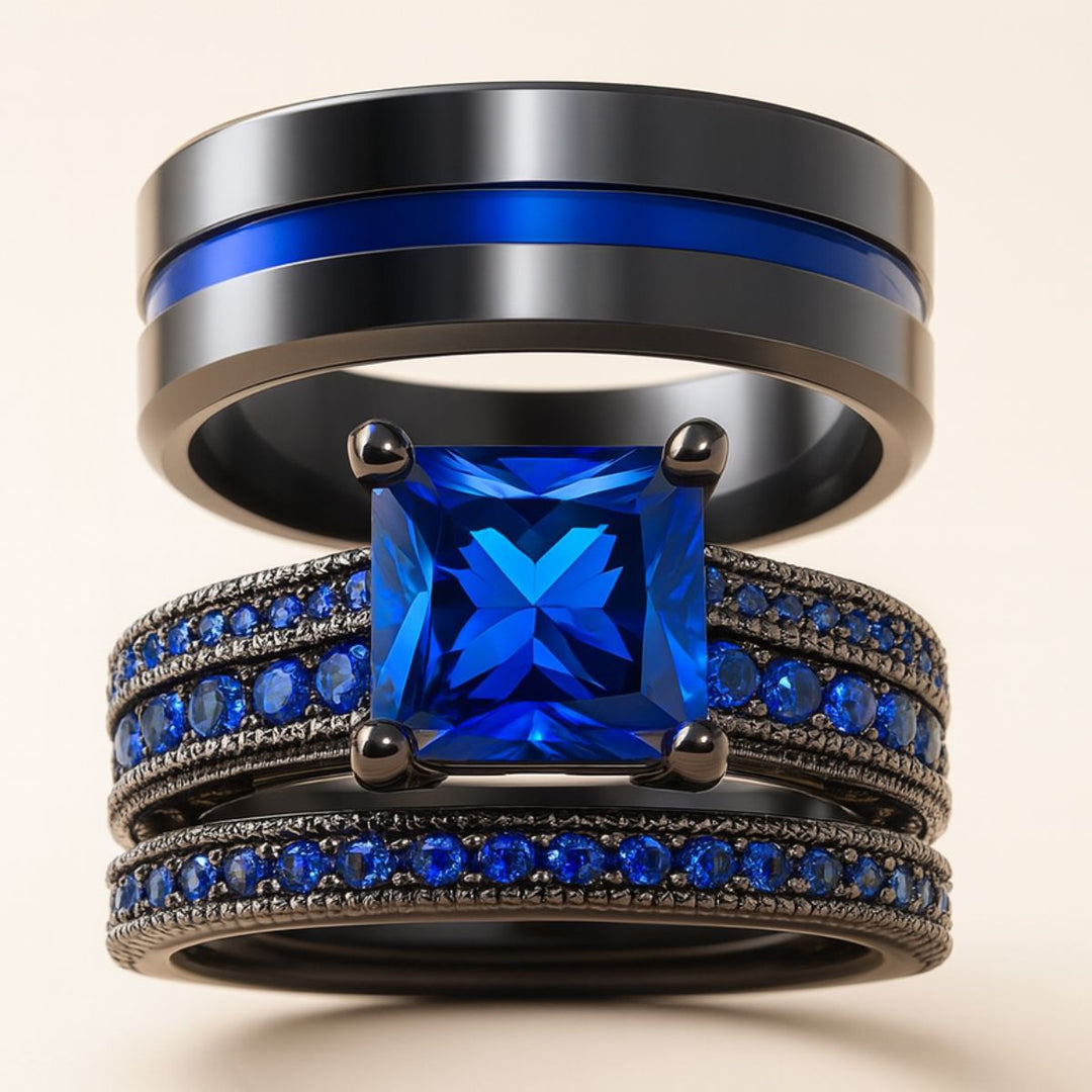 Love Dance ring set by CouplesChoices.com, featuring a bold black titanium band with electric blue inlay and a radiant princess-cut sapphire atop pavé-set blue stones—designed to move hearts.