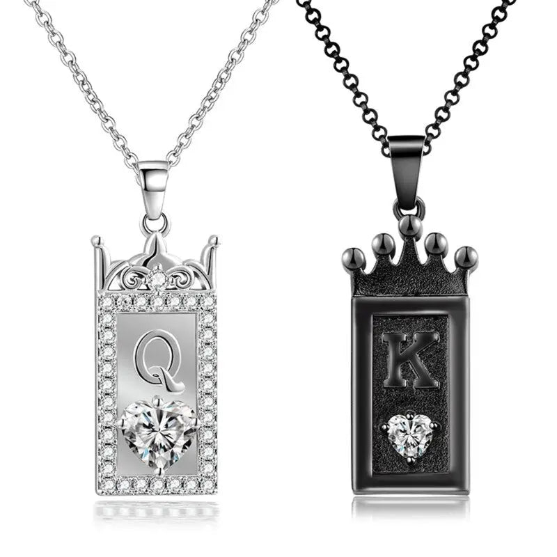 Matching King and Queen necklaces from CouplesChoices.com—black crown pendant with “K” for him and silver gem-framed pendant with “Q” for her. A bold, regal expression of love, loyalty, and royal couple energy.