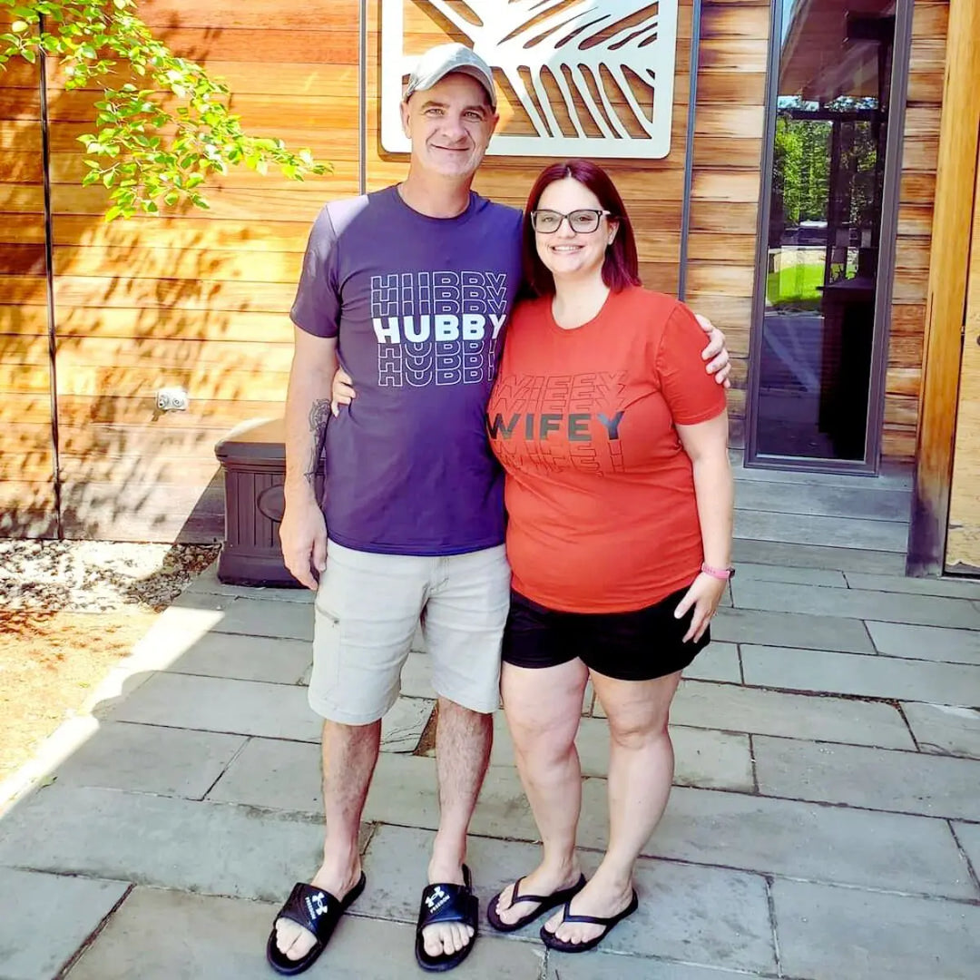 Matching couple shirts from CouplesChoices.com featuring bold “HUBBY” in white on navy and “WIFEY” in black on maroon. A modern, stylish way for married couples to celebrate love, unity, and commitment in everyday fashion.
