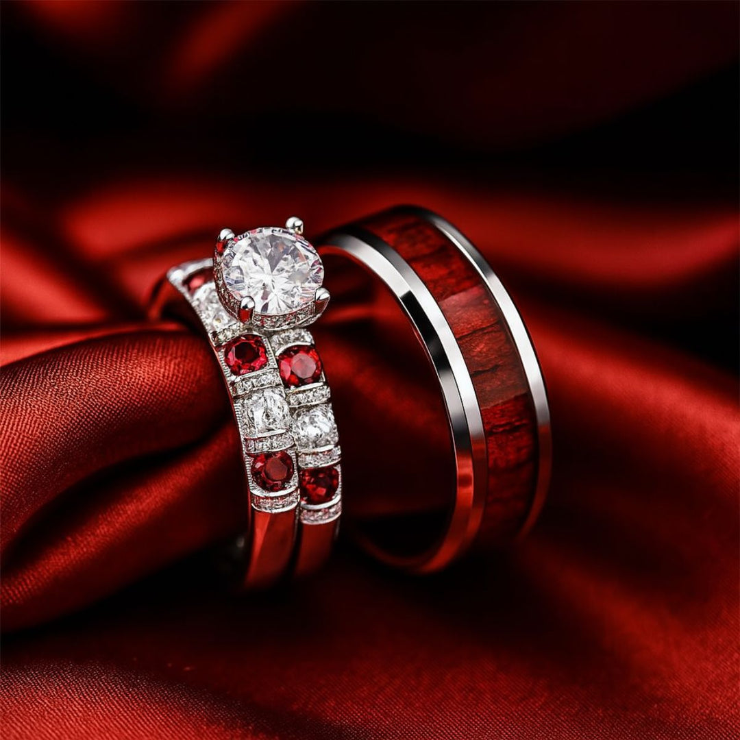 Red Love ring set by CouplesChoices.com, featuring a heart-shaped diamond atop vintage pavé bands with ruby red and white stones, paired with a polished redwood inlay band for timeless romance.