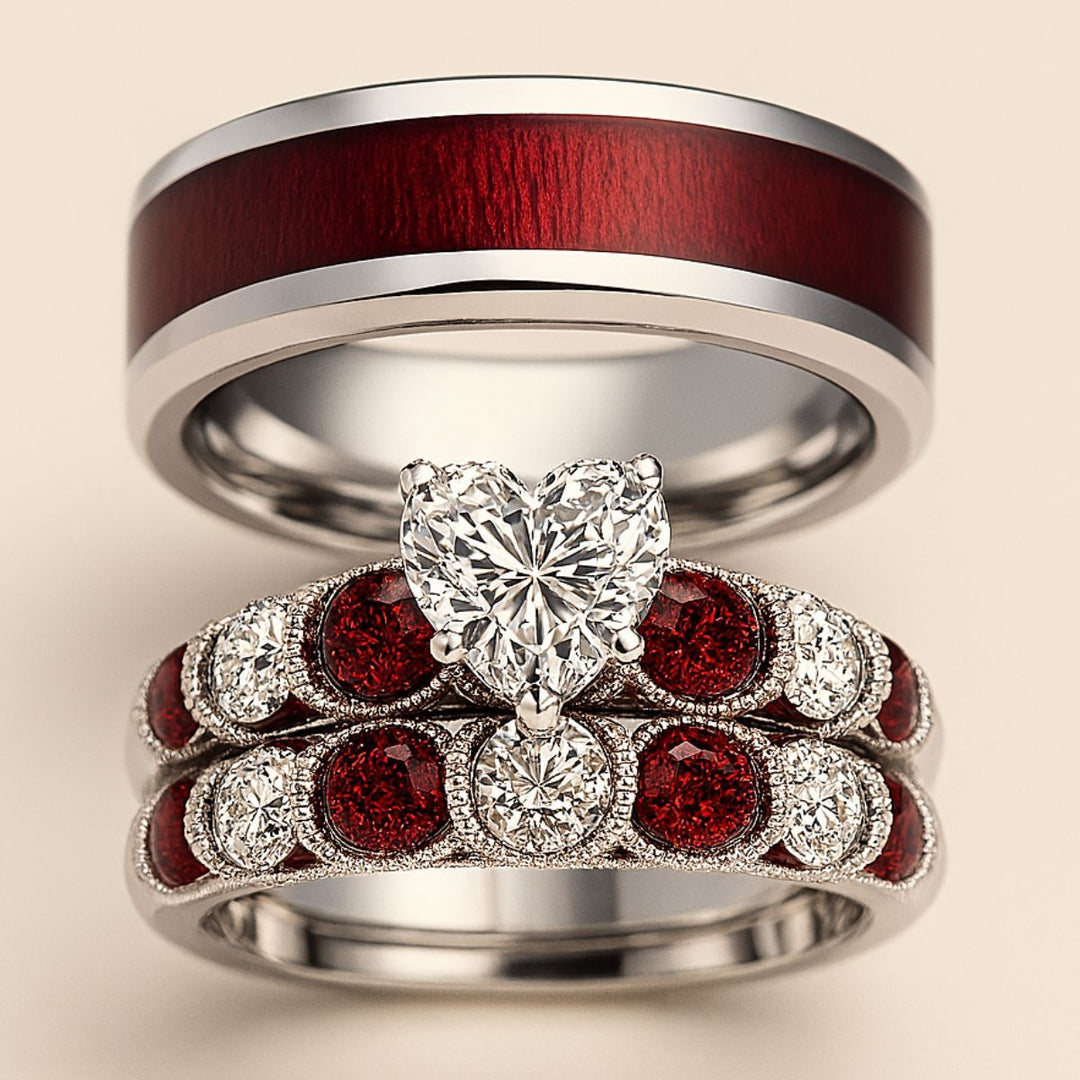 Red Love ring set by CouplesChoices.com, featuring a heart-shaped diamond atop vintage pavé bands with ruby red and white stones, paired with a polished redwood inlay band for timeless romance.