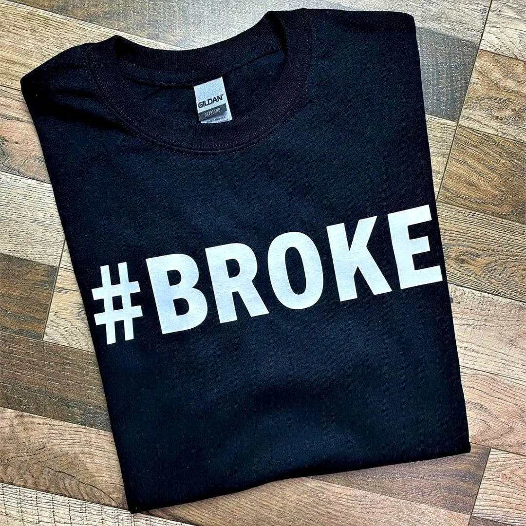 Couples' black matching tees—his says '#Broke', hers reads '#Spoiled' in bold white text. A hilarious and relatable duo for couples who know love isn’t always 50/50. From CouplesChoices.com.