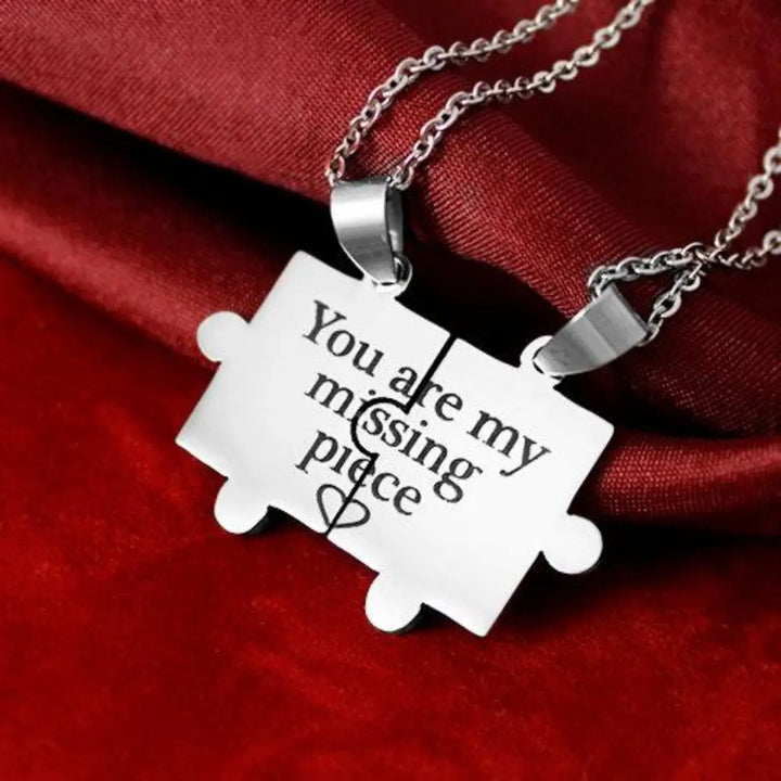Matching couple necklaces from CouplesChoices.com featuring two interlocking puzzle pieces engraved with “You are my missing piece” and a shared heart design—symbolizing love, unity, and perfect connection.