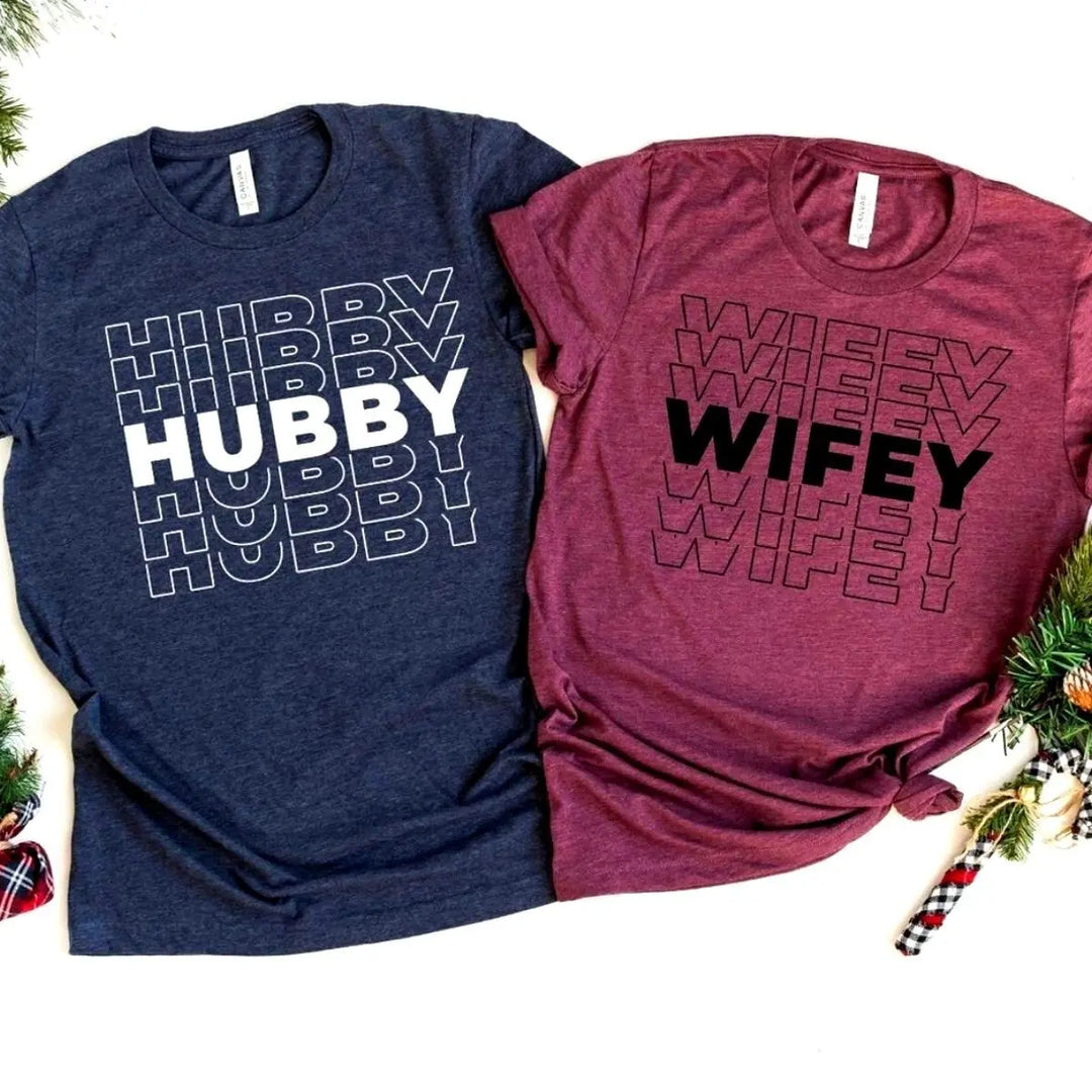 Matching couple shirts from CouplesChoices.com featuring bold “HUBBY” in white on navy and “WIFEY” in black on maroon. A modern, stylish way for married couples to celebrate love, unity, and commitment in everyday fashion.