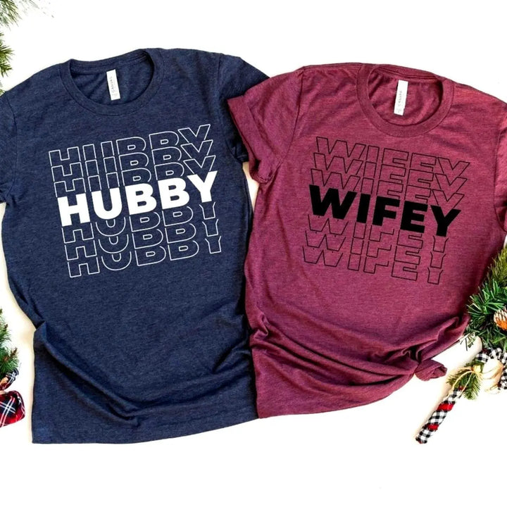 Matching couple shirts from CouplesChoices.com featuring bold “HUBBY” in white on navy and “WIFEY” in black on maroon. A modern, stylish way for married couples to celebrate love, unity, and commitment in everyday fashion.