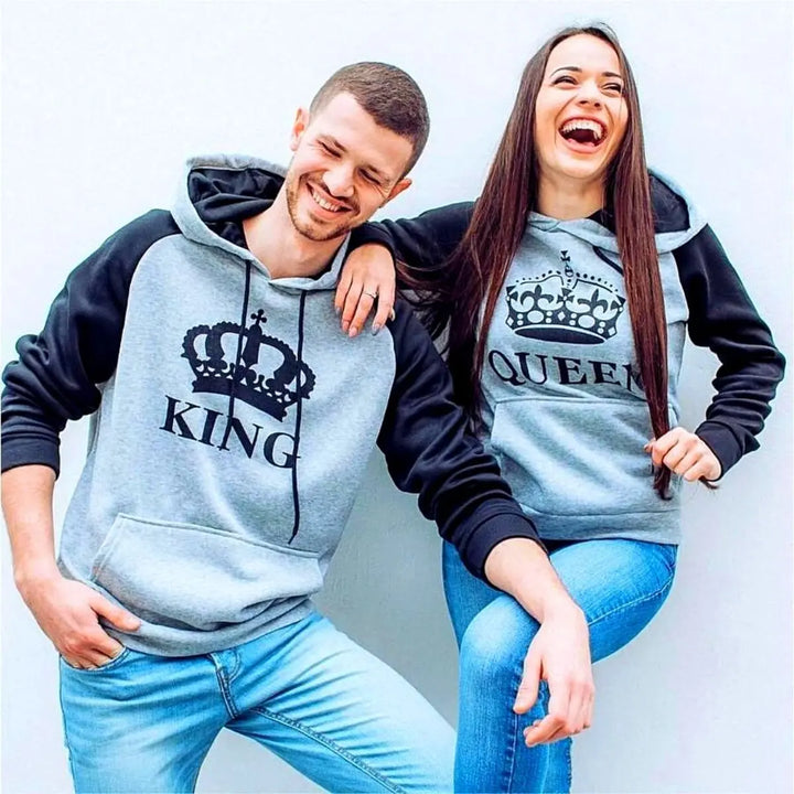 Matching heather gray and black couple hoodies from CouplesChoices.com featuring bold black “KING” and “QUEEN” lettering with royal crown graphics. A sleek and modern set designed for couples who wear their love with confidence and class.