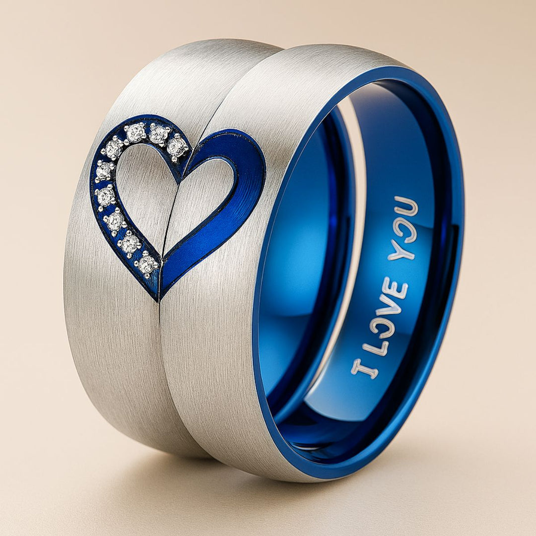 Adore Rings by CouplesChoices.com – brushed silver matching couple rings with sapphire blue interior, forming a heart when placed together. One ring features sparkling cubic zirconia stones, symbolizing unity and eternal love.