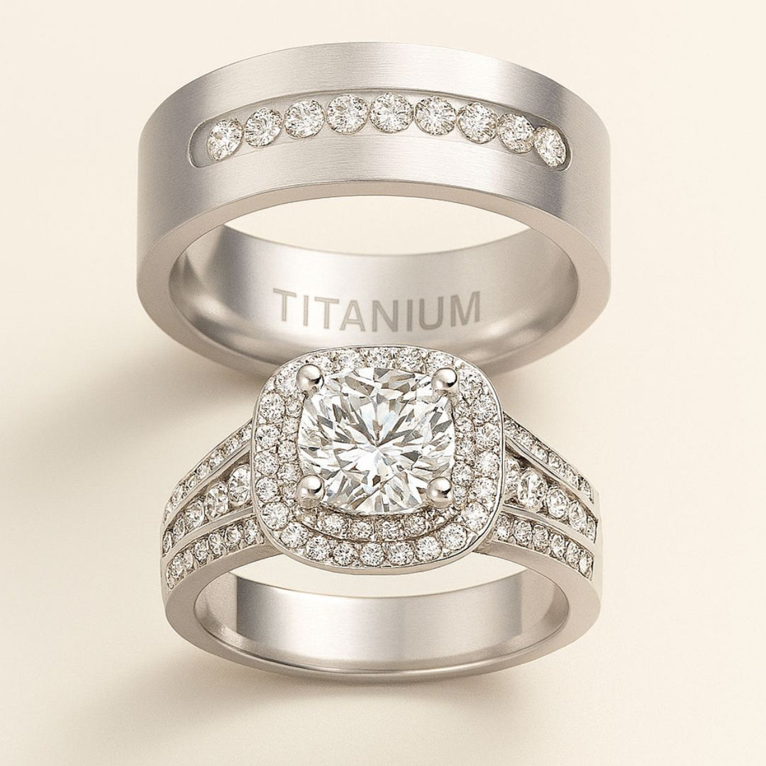 Aurora Rings by CouplesChoices.com – a breathtaking titanium wedding set featuring a cushion-cut center stone, double halo pavé design, and a sleek men’s band with channel-set brilliance for a timeless, luxurious finish.