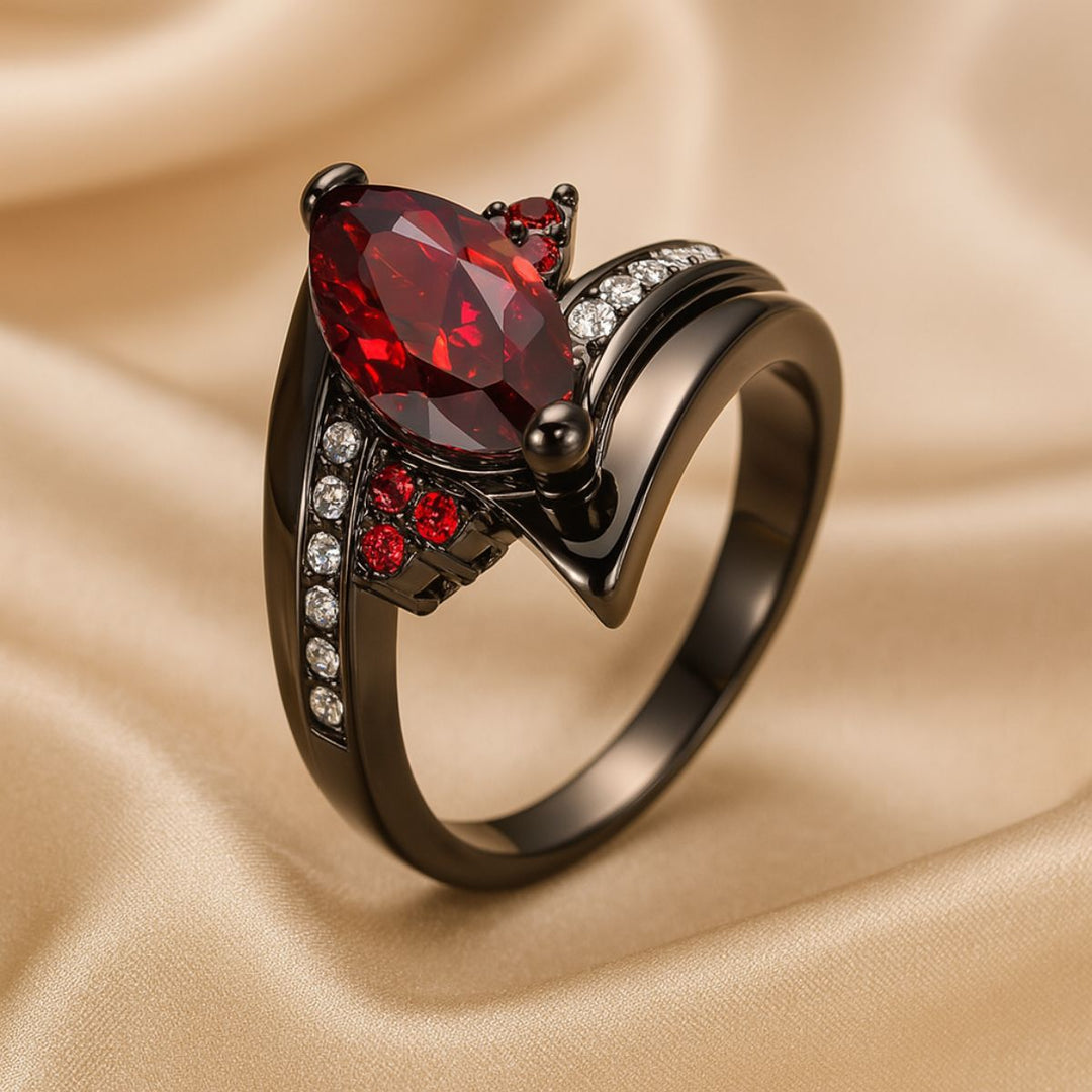 Bold and elegant Red Velvet ring set from CouplesChoices.com, crafted in black titanium with a marquise-cut red center stone, pavé accents, and a red Celtic infinity inlay symbolizing eternal passion.