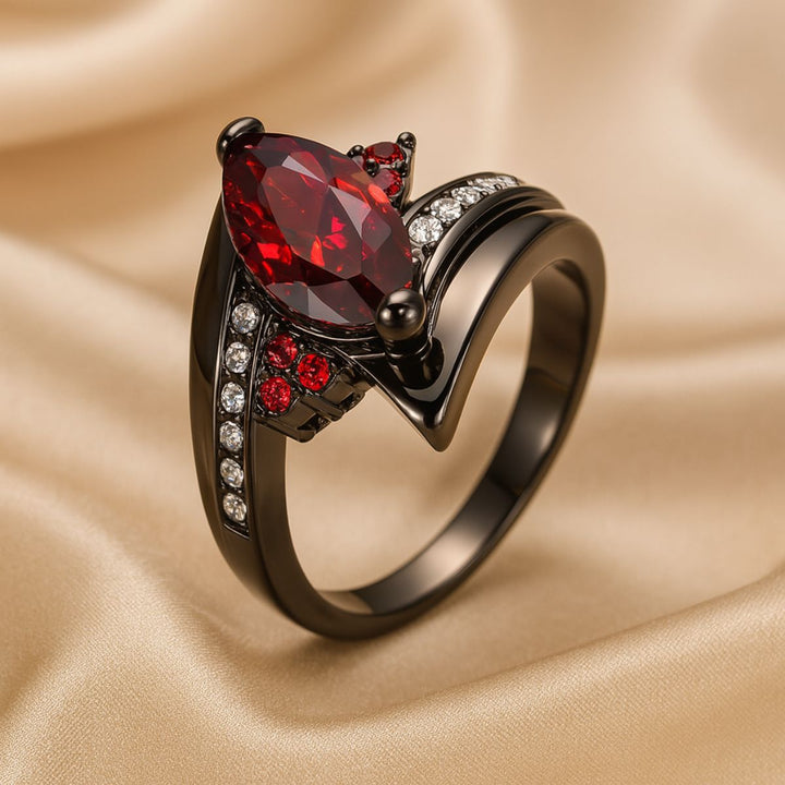 Bold and elegant Red Velvet ring set from CouplesChoices.com, crafted in black titanium with a marquise-cut red center stone, pavé accents, and a red Celtic infinity inlay symbolizing eternal passion.