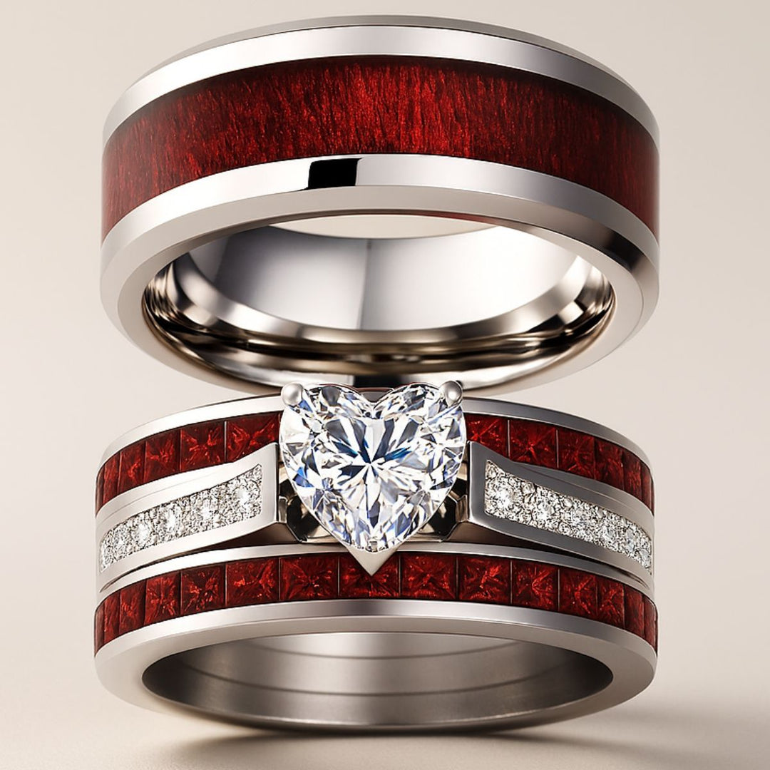 Bold and romantic, the Love Passion Rings by CouplesChoices.com feature a heart-shaped diamond centerpiece, flanked by radiant red inlays and shimmering pavé-set stones, symbolizing eternal devotion in striking style.