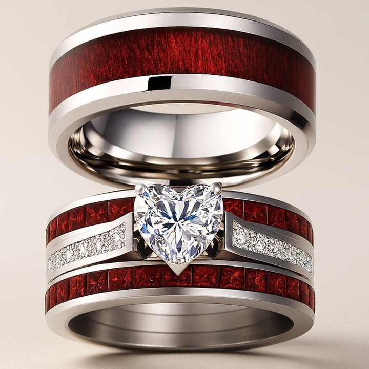 Bold and romantic, the Love Passion Rings by CouplesChoices.com feature a heart-shaped diamond centerpiece, flanked by radiant red inlays and shimmering pavé-set stones, symbolizing eternal devotion in striking style.