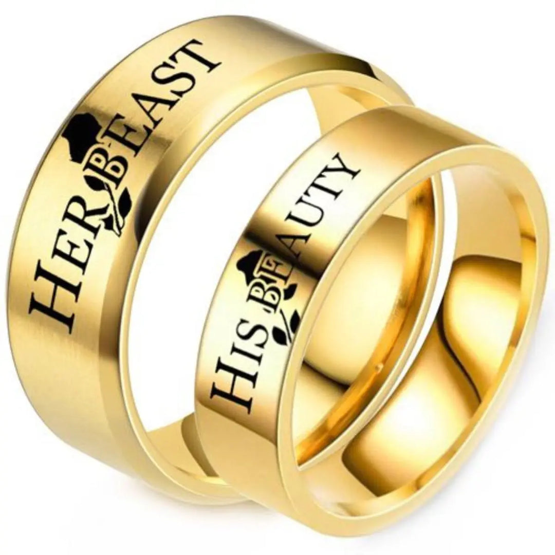 Celebrate timeless love with the Demure Rose Rings from CouplesChoices.com—gold bands engraved with “Her Beast” and “His Beauty,” symbolizing a powerful, elegant bond inspired by a tale as old as time.
