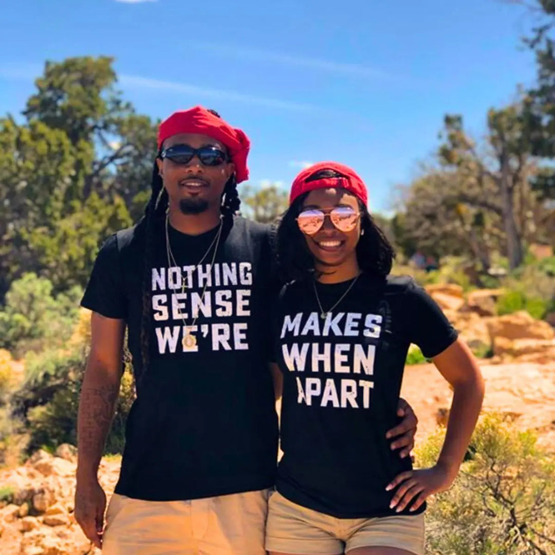 Couple wearing matching black shirts that read 'Nothing Makes Sense We’re' and 'Makes When Apart'—a playful and heartfelt message when worn together. Perfect for couples who want to show love and humor. From CouplesChoices.com.