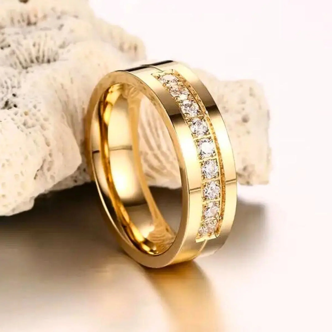 CouplesChoices.com Gold Royalty Rings – A radiant bridal set with a princess-cut diamond and pavé accents, paired with a bold men’s gold band featuring channel-set diamonds. A powerful symbol of regal love and lifelong unity.