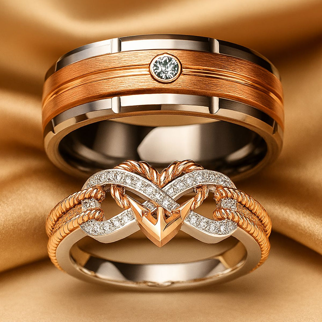 CouplesChoices.com Love Again Rings – Matching set with a men’s brushed rose gold and tungsten band featuring a bezel-set diamond, and a women’s infinity-heart ring in rose gold and pavé diamonds. Elegant symbols of timeless love.