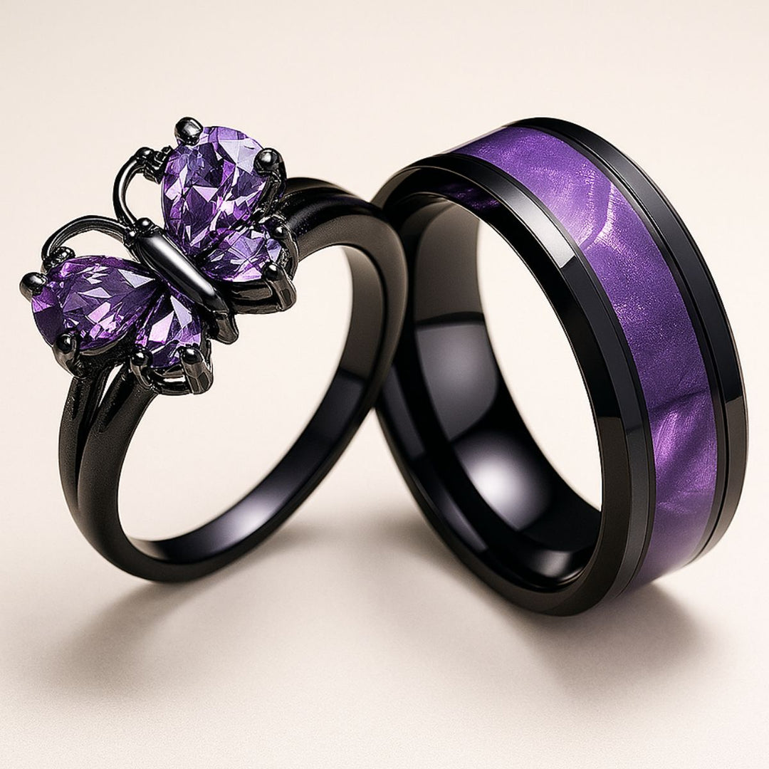 CouplesChoices.com Purple Wings Rings – A striking black-plated set featuring a butterfly-shaped amethyst ring and a matching band with shimmering violet inlay. Bold, romantic, and beautifully symbolic of transformation and eternal love.