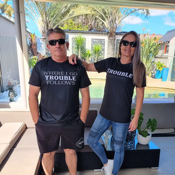 Couples black matching shirts from CouplesChoices.com—one reads “WHERE I GO TROUBLE FOLLOWS,” the other simply says “TROUBLE.” A cheeky, confident way to show playful love and unforgettable chemistry.