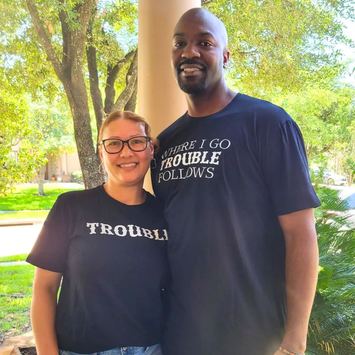 Couples black matching shirts from CouplesChoices.com—one reads “WHERE I GO TROUBLE FOLLOWS,” the other simply says “TROUBLE.” A cheeky, confident way to show playful love and unforgettable chemistry.