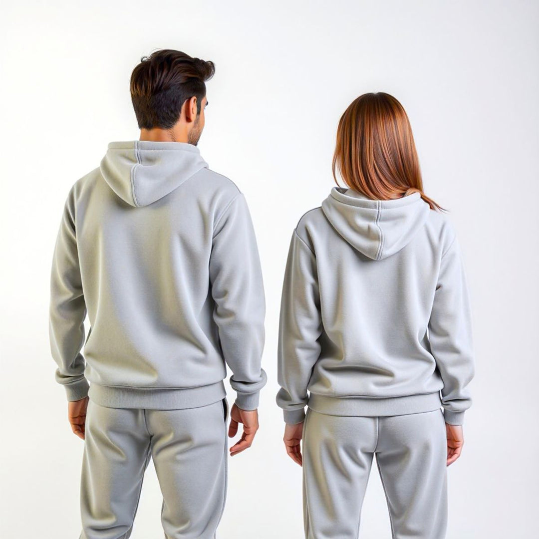 Couples confidently showcasing matching grey tracksuits from CouplesChoices.com, blending elevated comfort and minimalist style—ideal for modern loungewear or coordinated casual outings.