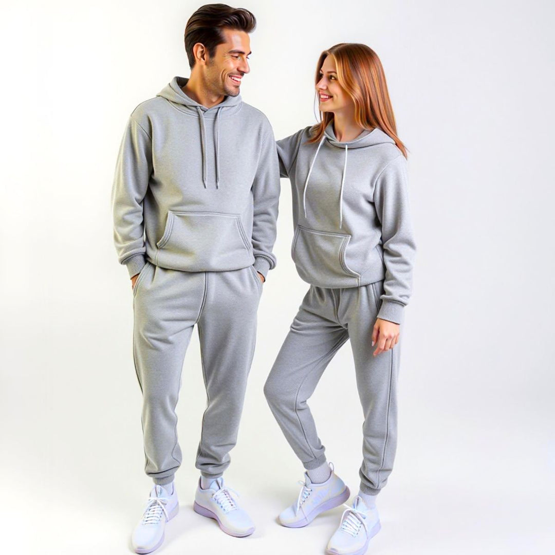 Couples confidently showcasing matching grey tracksuits from CouplesChoices.com, blending elevated comfort and minimalist style—ideal for modern loungewear or coordinated casual outings.