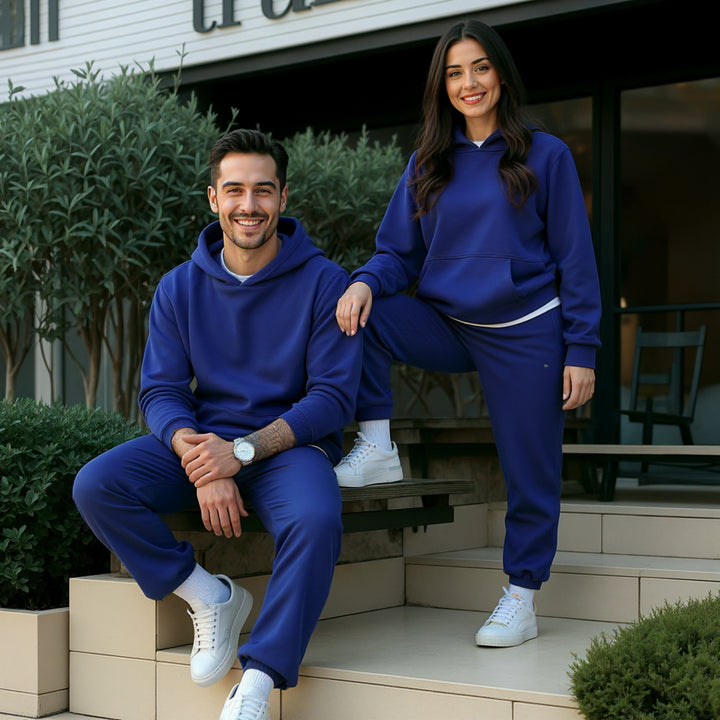 Couples dressed in vibrant royal blue matching tracksuits from CouplesChoices.com, combining bold color with modern loungewear design—crafted for statement comfort and elevated casualwear.