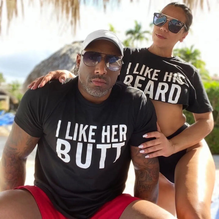 Couples matching black T-shirts from CouplesChoices.com—hers reads “I Like His Beard” and his says “I Like Her Butt.” A fun, cheeky way to show off attraction, personality, and a playful connection in modern relationships.