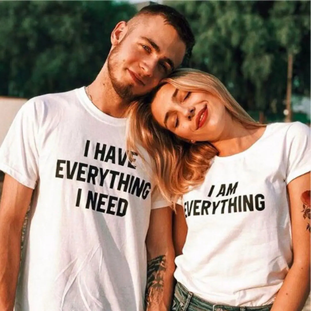 Couples matching white T-shirts from CouplesChoices.com—his says “I Have Everything I Need,” hers says “I Am Everything”—a bold, stylish way to express love, unity, and connection.