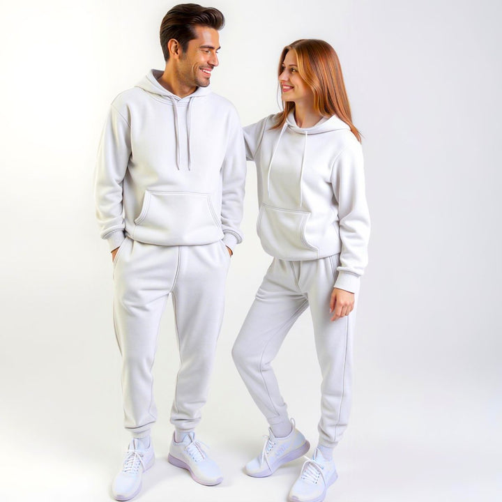 Couples styled in crisp white matching tracksuits from CouplesChoices.com, delivering a clean, minimalist aesthetic with premium comfort—designed for elevated everyday wear.