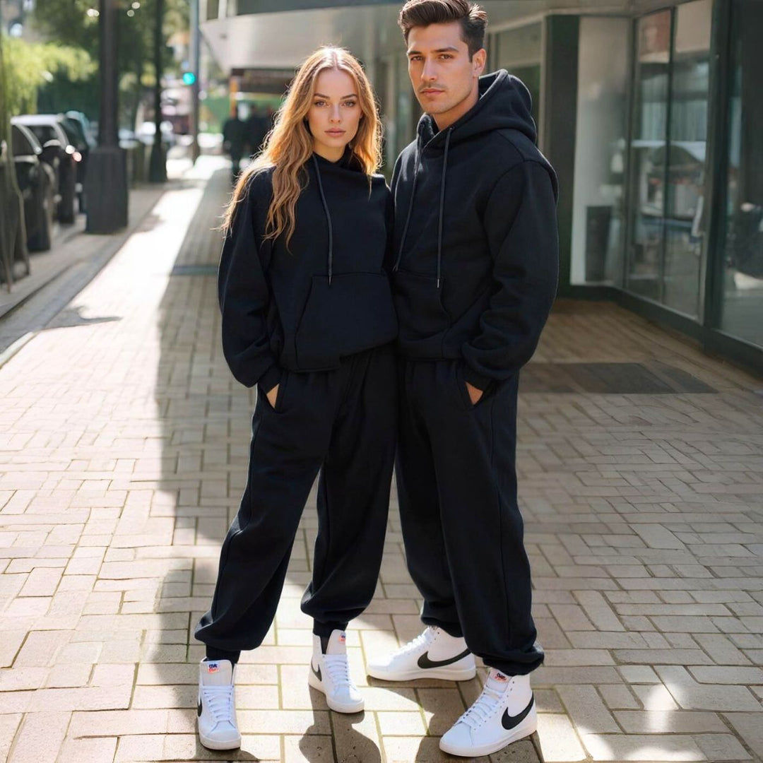Couples styled in sleek black matching tracksuits from CouplesChoices.com, embodying elevated comfort and timeless streetwear appeal—perfect for bold, coordinated looks in any setting.
