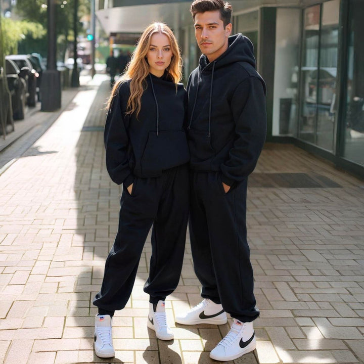 Couples styled in sleek black matching tracksuits from CouplesChoices.com, embodying elevated comfort and timeless streetwear appeal—perfect for bold, coordinated looks in any setting.