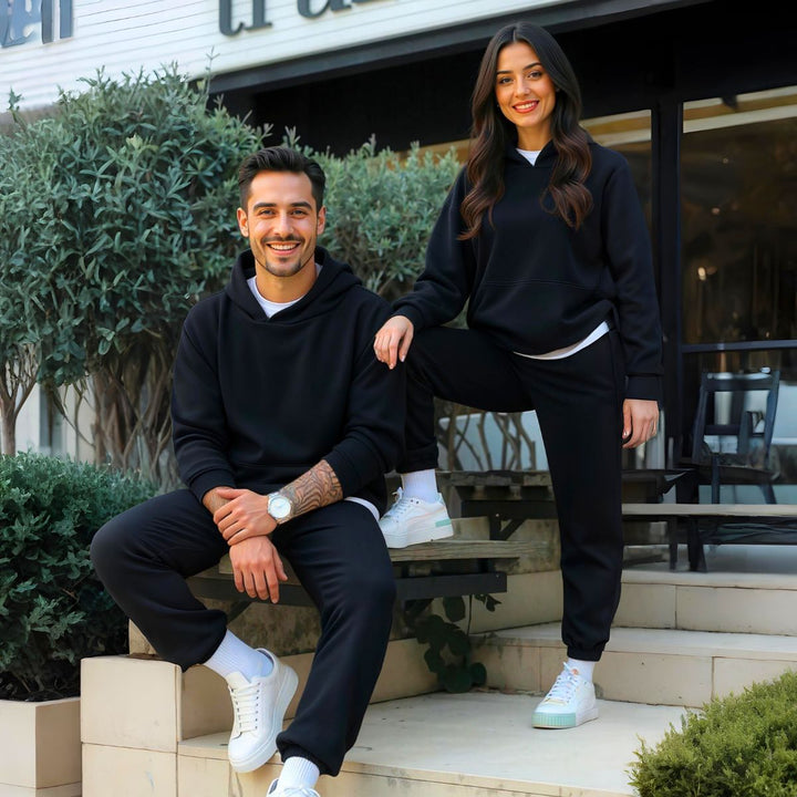 Couples styled in sleek black matching tracksuits from CouplesChoices.com, embodying elevated comfort and timeless streetwear appeal—perfect for bold, coordinated looks in any setting.