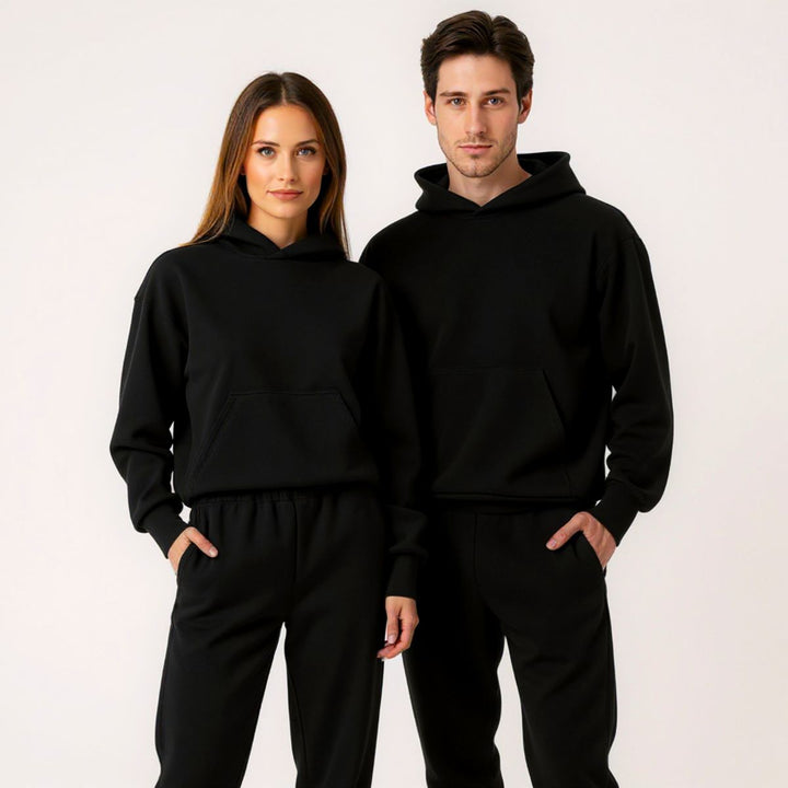 Couples styled in sleek black matching tracksuits from CouplesChoices.com, embodying elevated comfort and timeless streetwear appeal—perfect for bold, coordinated looks in any setting.