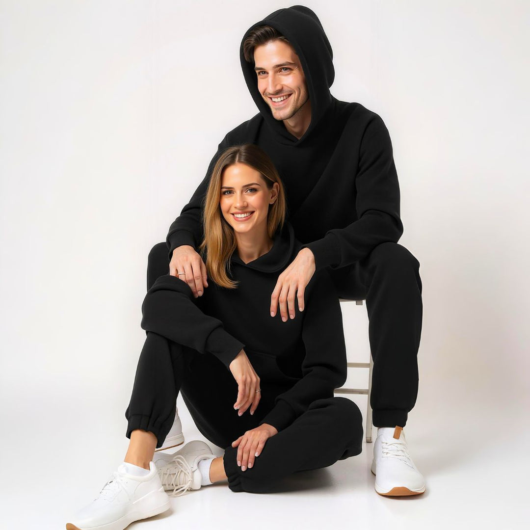 Couples styled in sleek black matching tracksuits from CouplesChoices.com, embodying elevated comfort and timeless streetwear appeal—perfect for bold, coordinated looks in any setting.