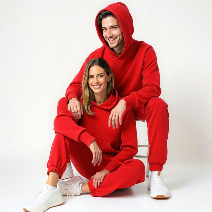 Couples wearing bold red matching tracksuits from CouplesChoices.com, merging high-impact color with elevated comfort—designed for standout coordination in everyday streetwear.