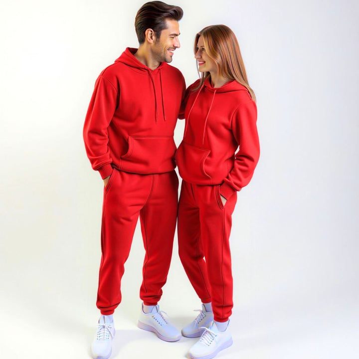 Couples wearing bold red matching tracksuits from CouplesChoices.com, merging high-impact color with elevated comfort—designed for standout coordination in everyday streetwear.