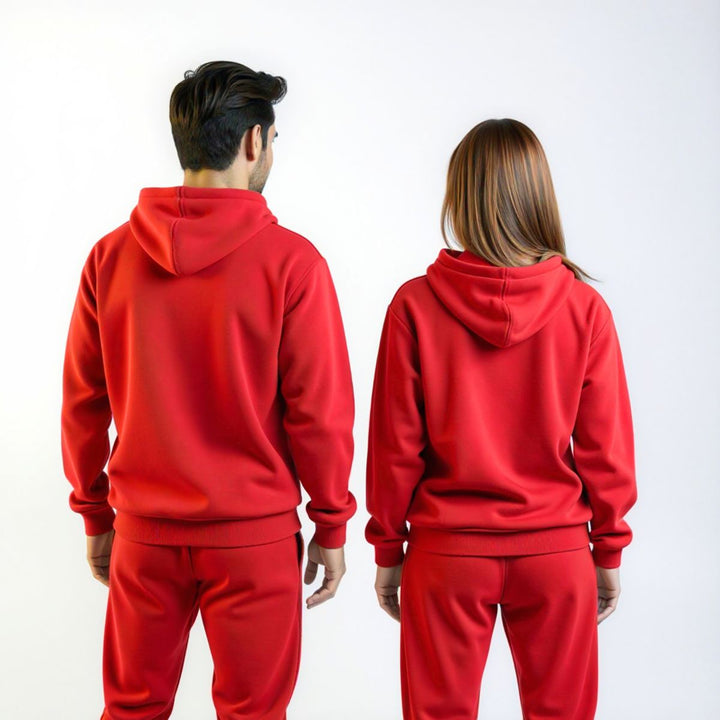 Couples wearing bold red matching tracksuits from CouplesChoices.com, merging high-impact color with elevated comfort—designed for standout coordination in everyday streetwear.