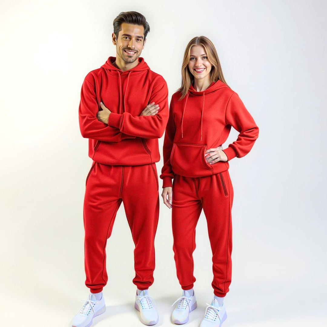 Couples wearing bold red matching tracksuits from CouplesChoices.com, merging high-impact color with elevated comfort—designed for standout coordination in everyday streetwear.