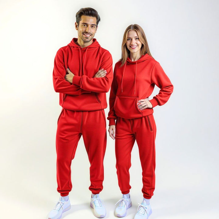 Couples wearing bold red matching tracksuits from CouplesChoices.com, merging high-impact color with elevated comfort—designed for standout coordination in everyday streetwear.