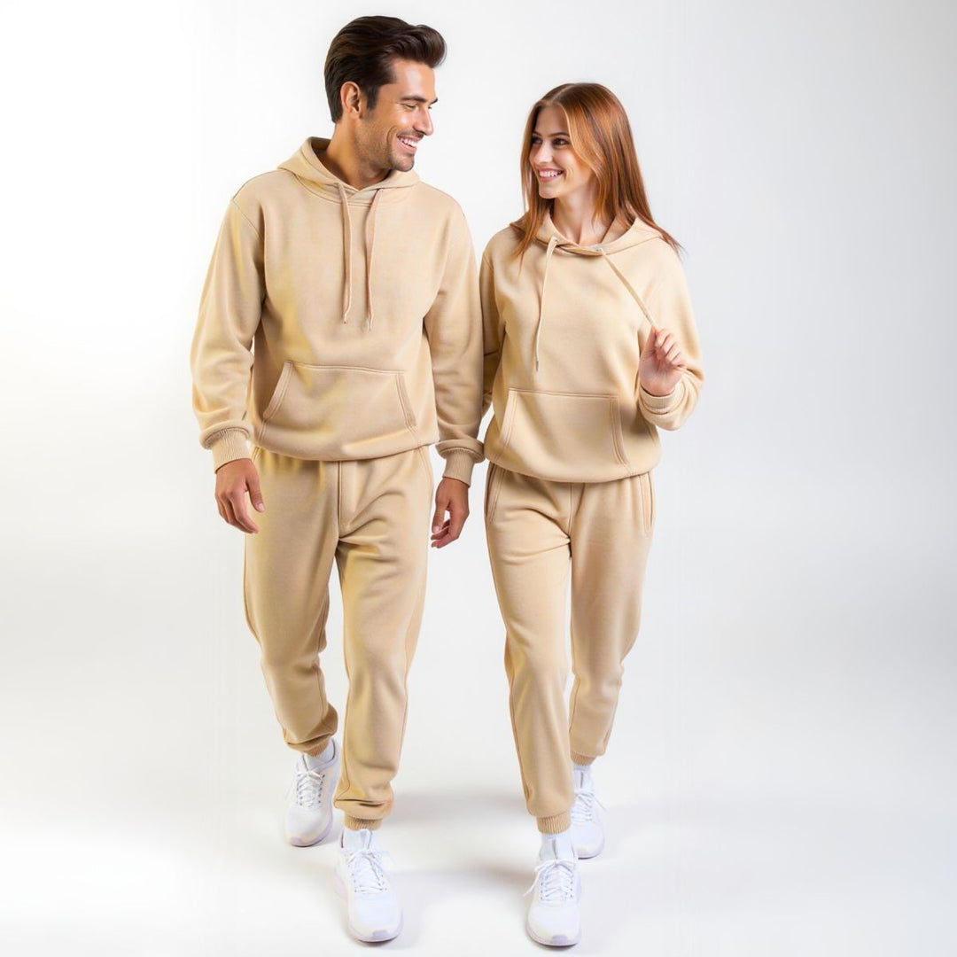 Couples wearing matching beige tracksuits from CouplesChoices.com, showcasing coordinated loungewear with a modern, minimalist design—perfect for casual outings or cozy indoor wear.