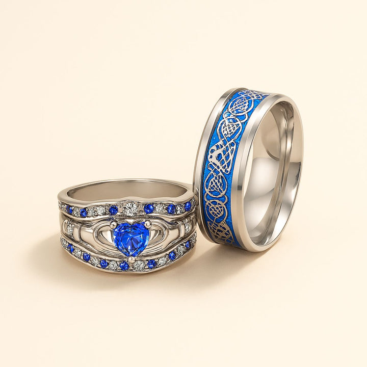 Deep Love Rings by CouplesChoices.com, featuring radiant sapphire-blue stones, Celtic-inspired details, and heart-shaped brilliance—crafted to celebrate powerful, lasting bonds with bold elegance.