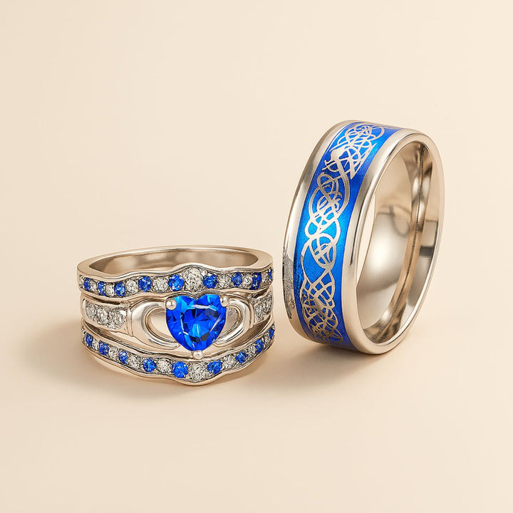 Deep Love Rings by CouplesChoices.com, featuring radiant sapphire-blue stones, Celtic-inspired details, and heart-shaped brilliance—crafted to celebrate powerful, lasting bonds with bold elegance.