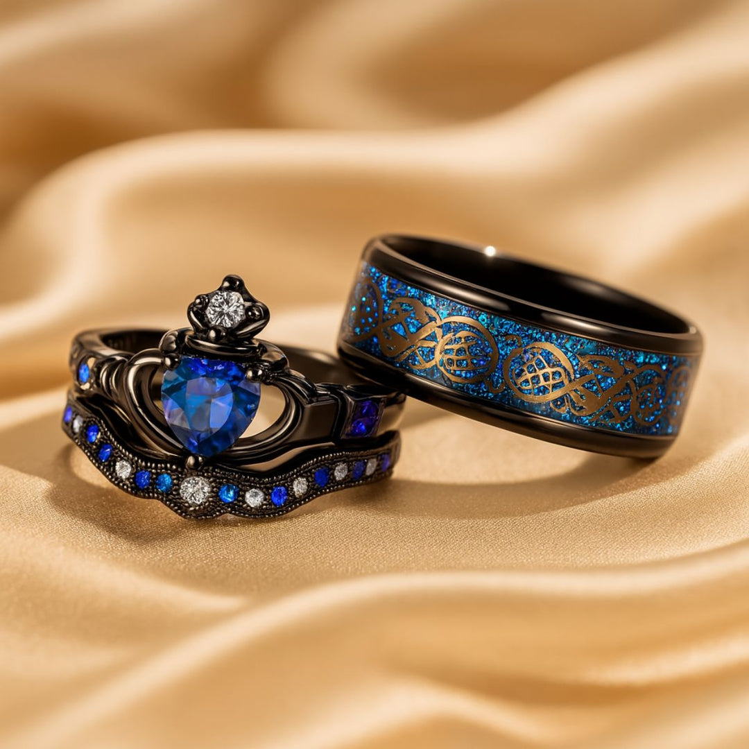 Elegant black titanium Unending Love ring set by CouplesChoices.com, featuring a sapphire heart, pavé-set stones, and a Celtic infinity pattern symbolizing eternal love.
