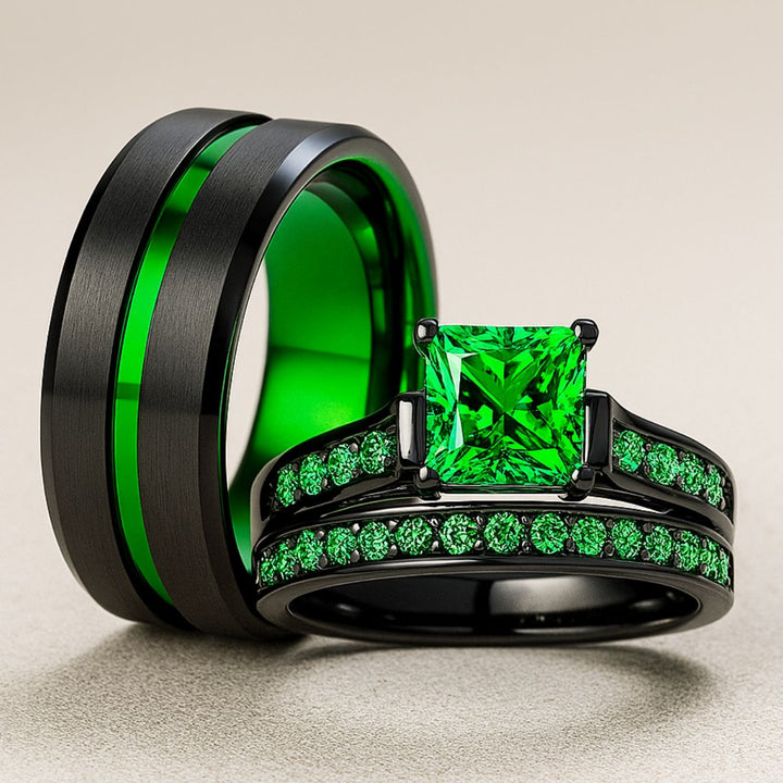 Emerald Breath Ring Set by CouplesChoices.com featuring a princess-cut green center stone on a black pavé band, paired with a brushed black men’s ring accented by a vivid emerald-green inlay.