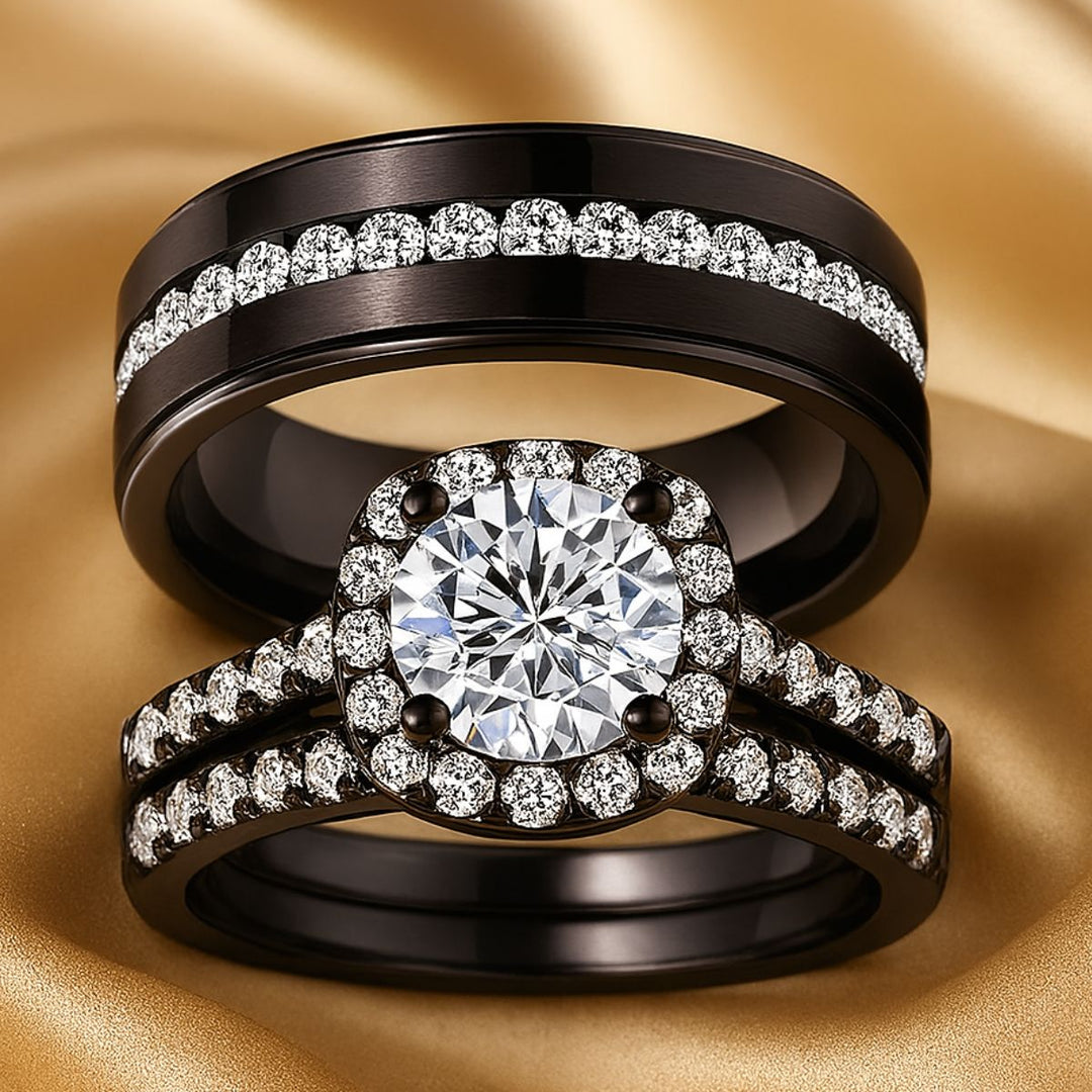 Euphoria Ring Set by CouplesChoices.com featuring a round-cut center stone on a black pavé halo setting, paired with a coordinating diamond-lined wedding band and a bold men’s ring with a full pavé channel.