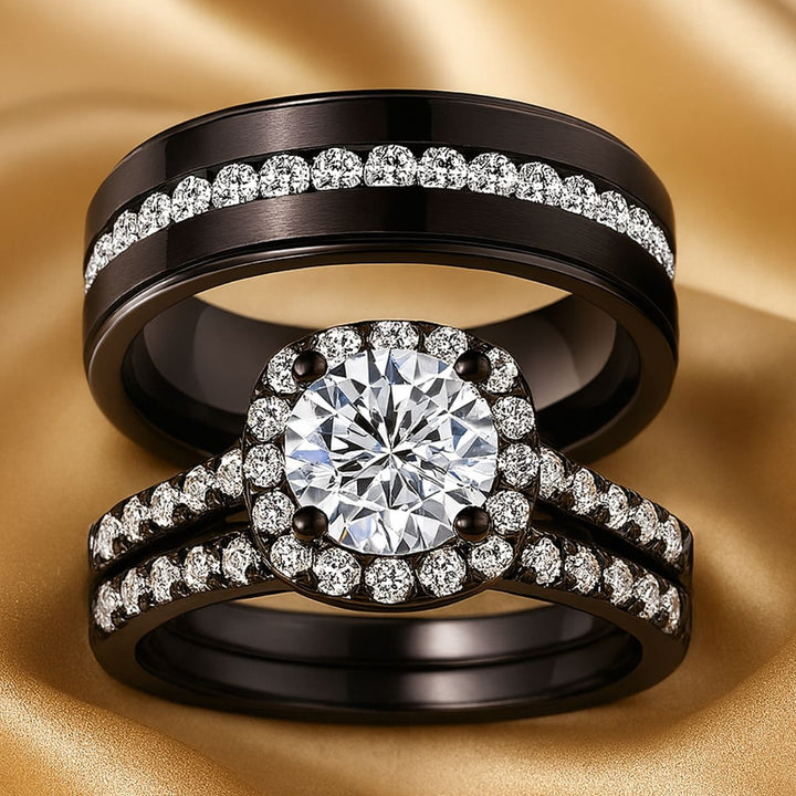 Euphoria Ring Set by CouplesChoices.com featuring a round-cut center stone on a black pavé halo setting, paired with a coordinating diamond-lined wedding band and a bold men’s ring with a full pavé channel.