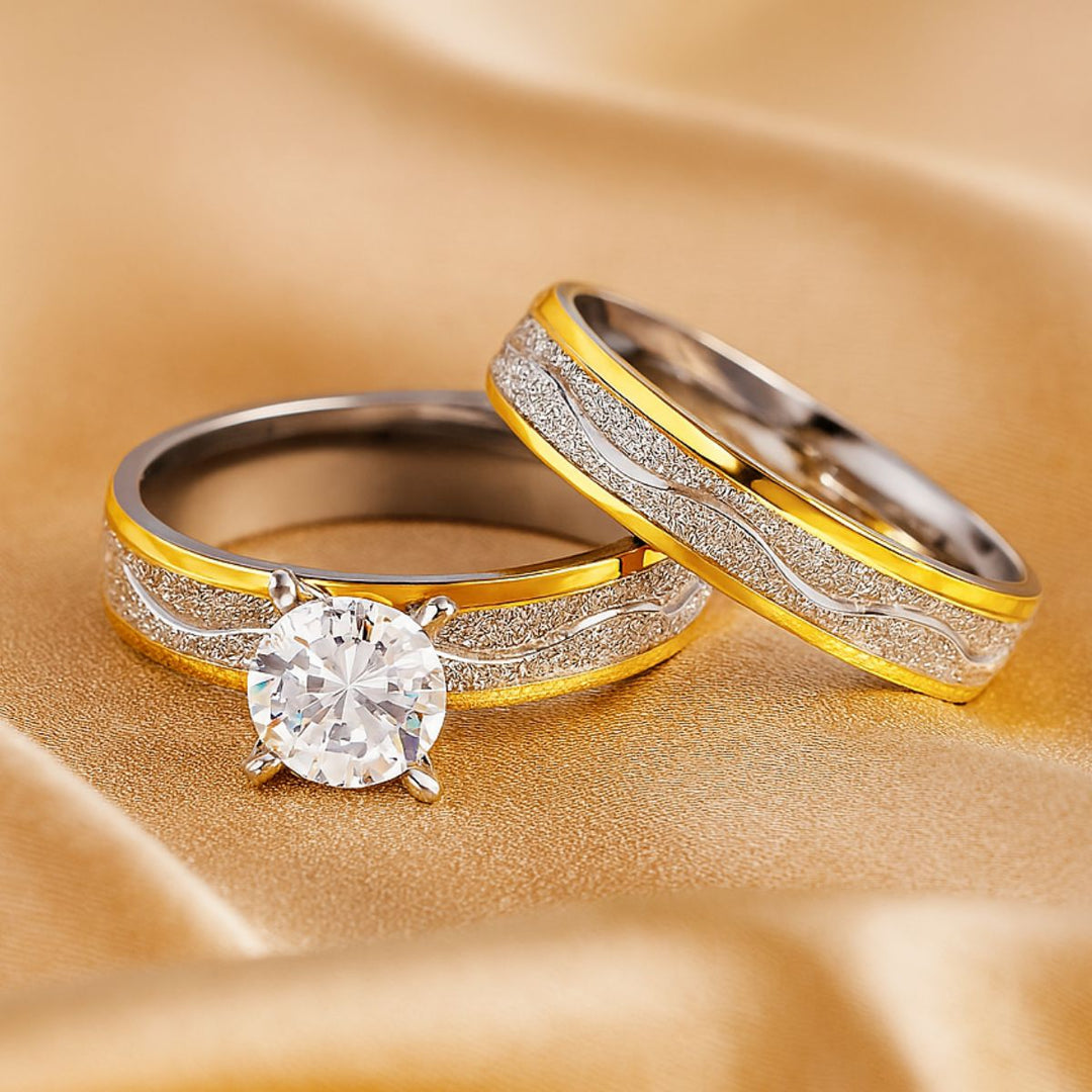 Fall in Love Rings by CouplesChoices.com—featuring a stunning round-cut solitaire and matching bands in silver and gold with textured wave accents. A radiant fusion of elegance and warmth, capturing the golden glow of timeless love.